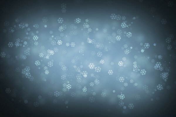 Flocons de neige tombant sur un ciel sombre